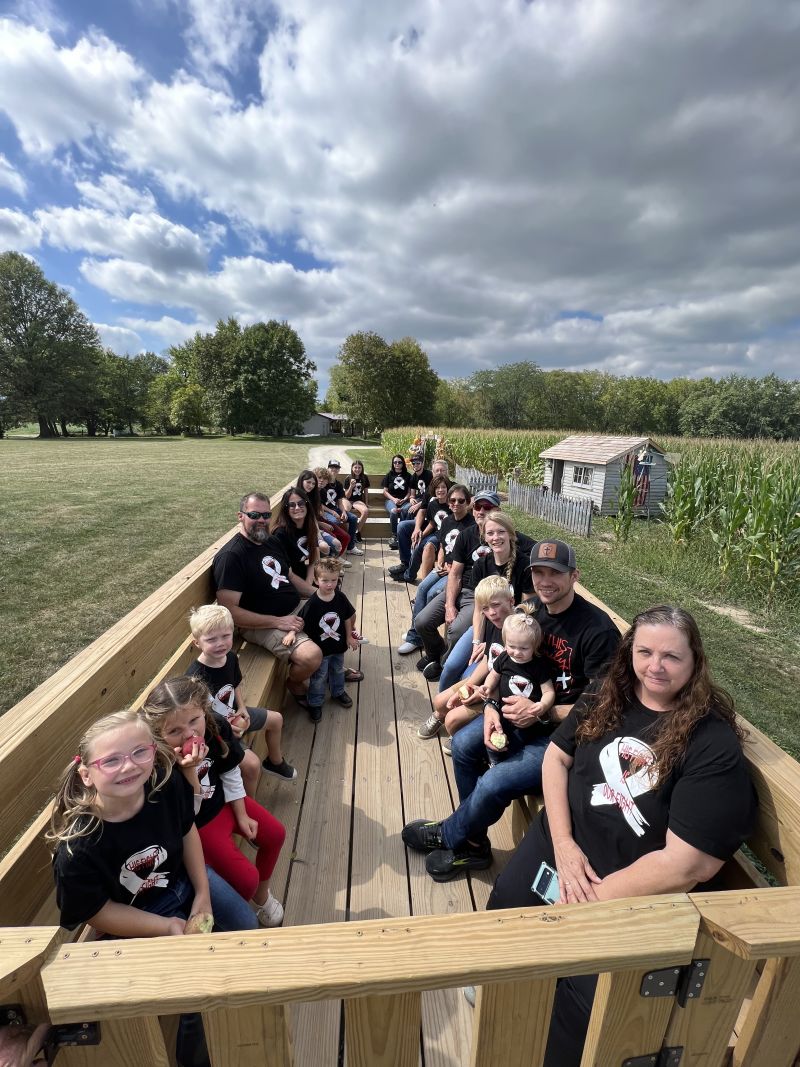 Big group of family and friends enjoying a scenic wagon ride around the farm.