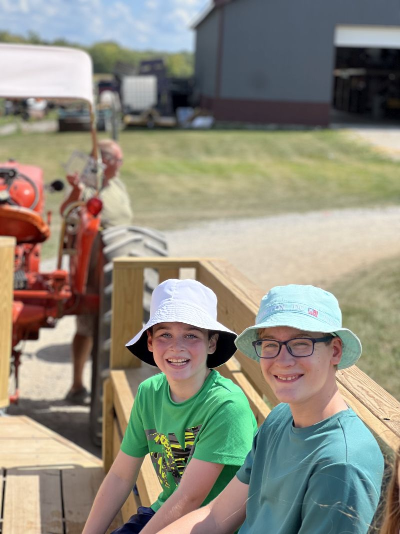 2 happy customers getting ready for a wagon ride around the farm.