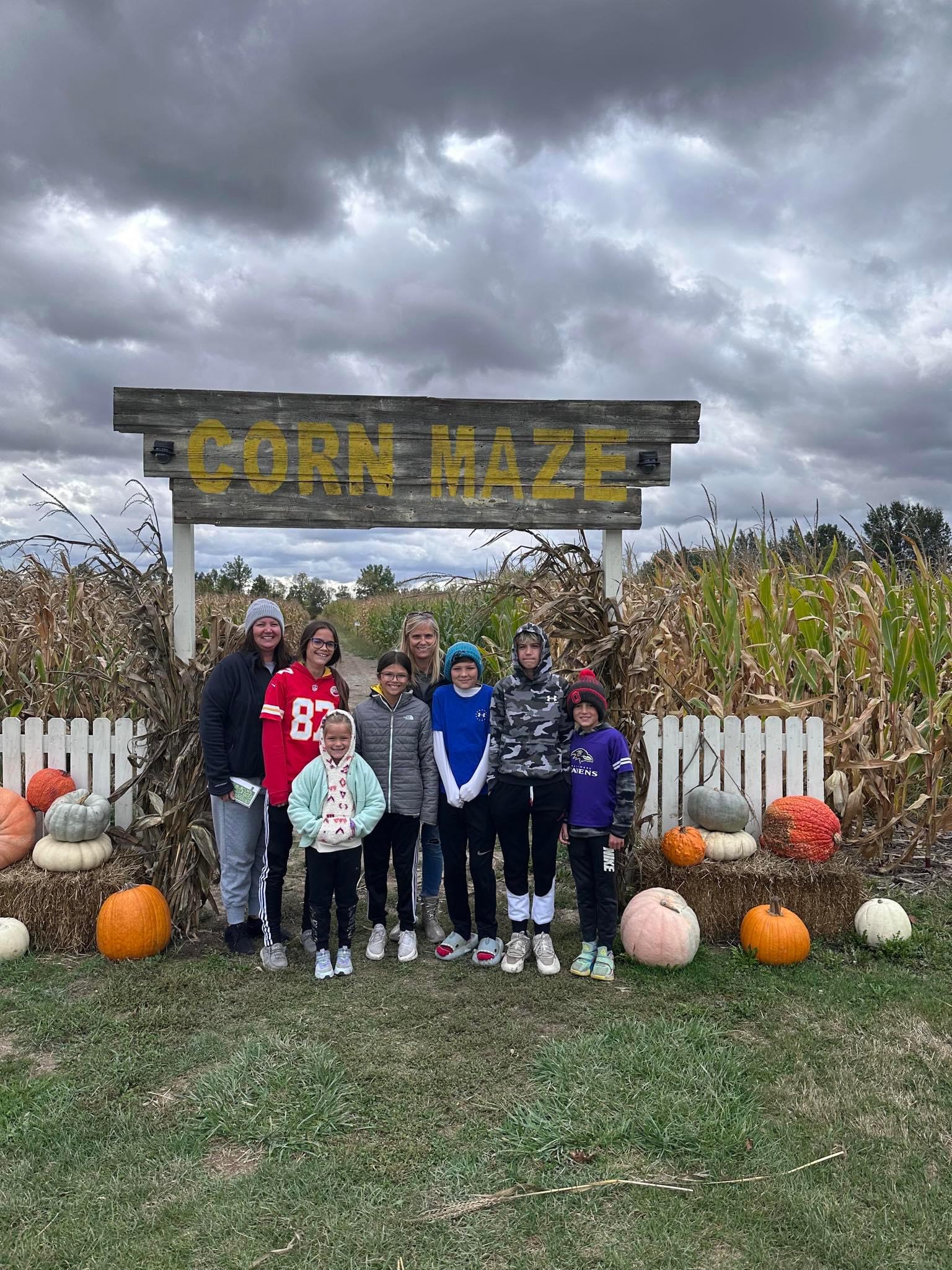 Family poses for a photo just before heading into the corn maze at the Weller Farm.